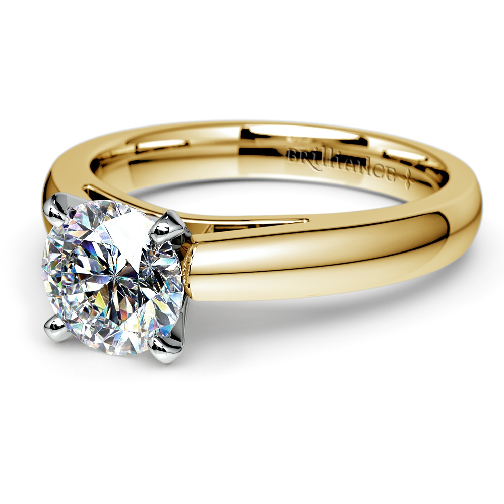 Solitaire Engagement Ring With Cathedral Setting In Gold