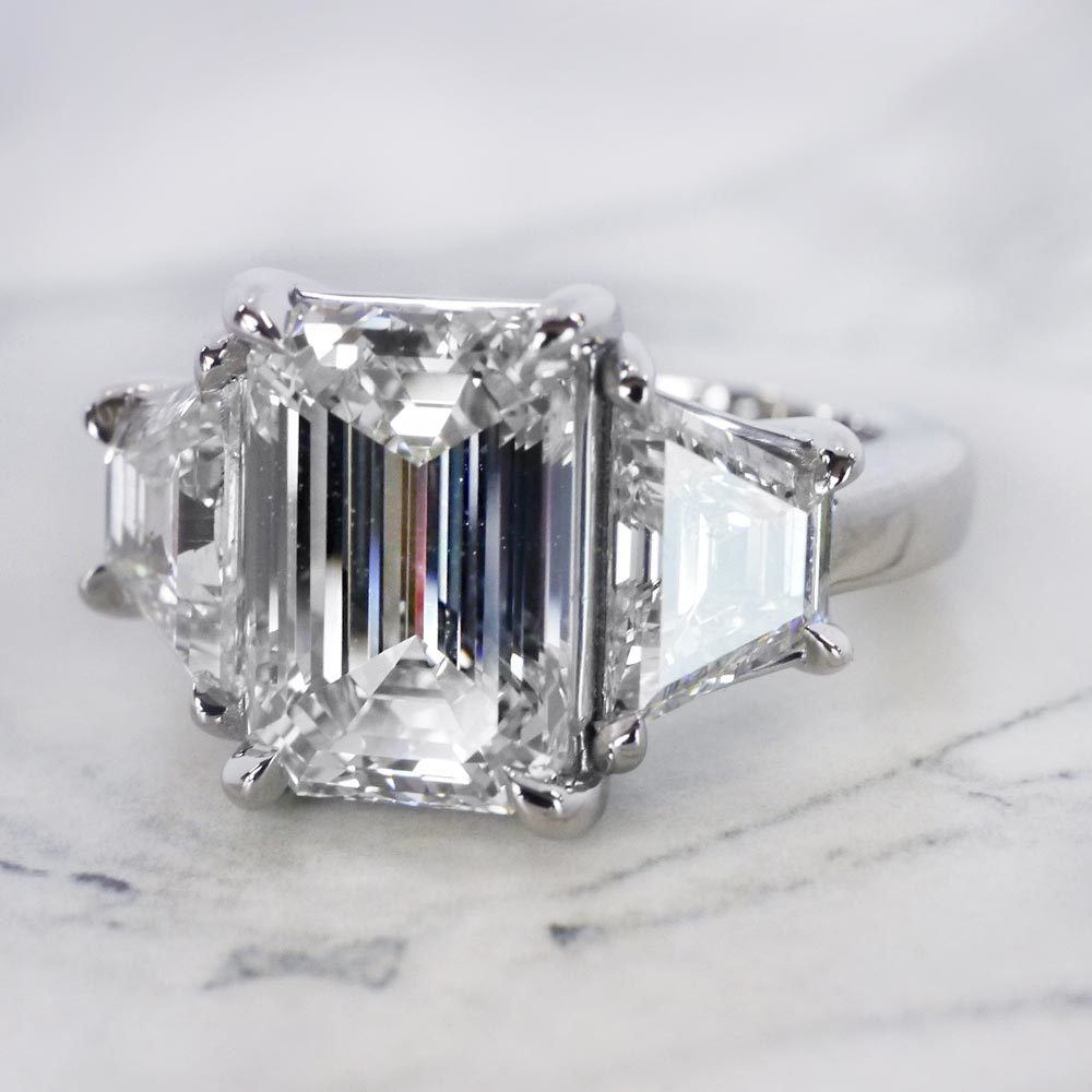 emerald cut diamond ring with trapezoid side stones